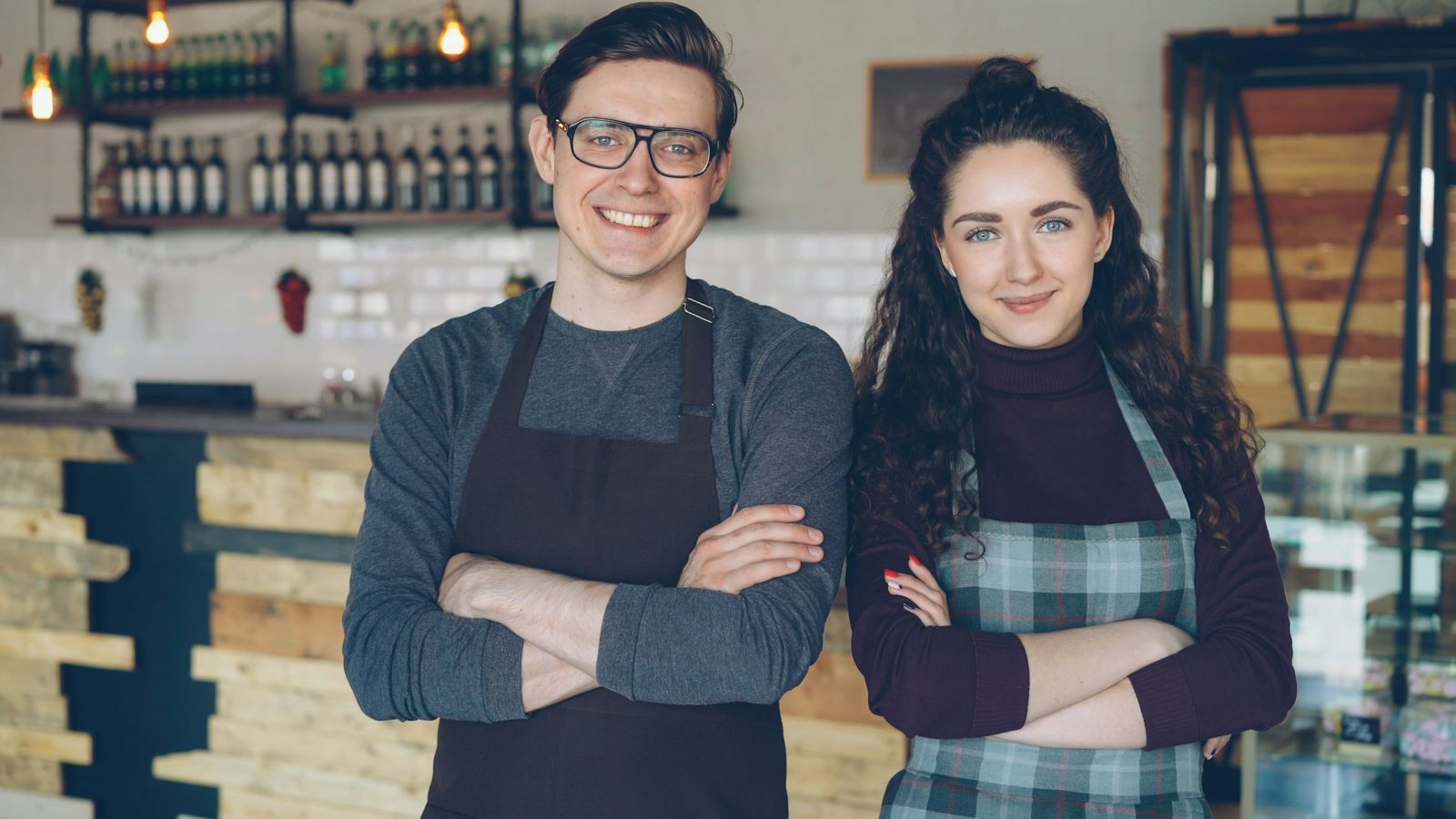 Two small business owners standing in their shop